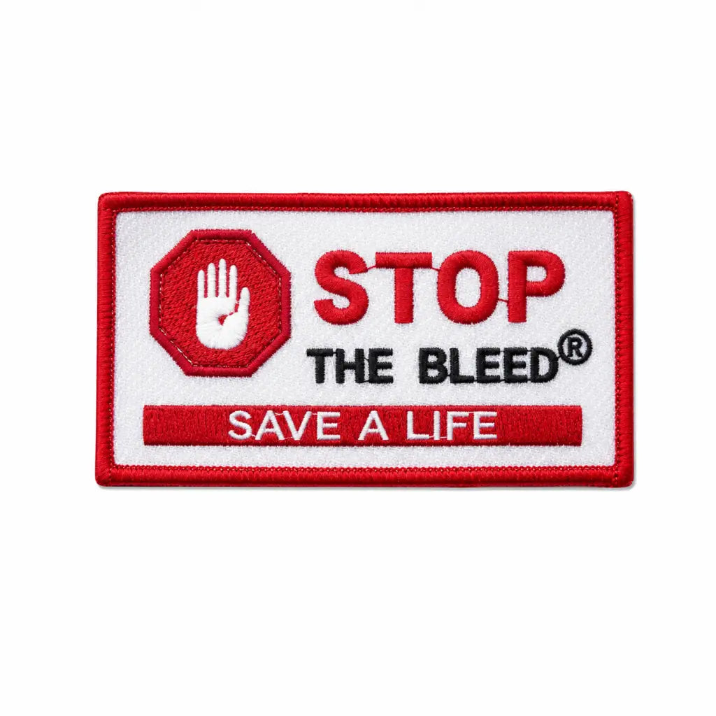 Patch retangular branco com borda vermelha; mão branca em octógono vermelho, STOP THE BLEED